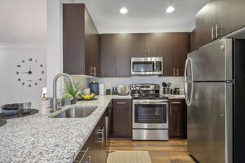 a kitchen with stainless steel appliances and granite counter tops